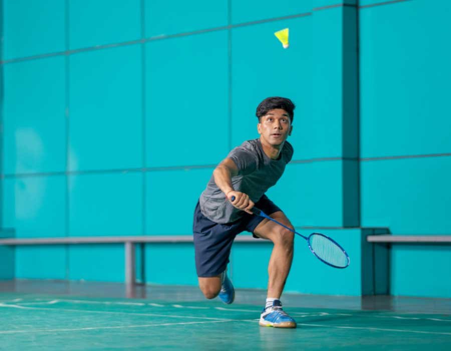Players enjoying badminton on a premium indoor court