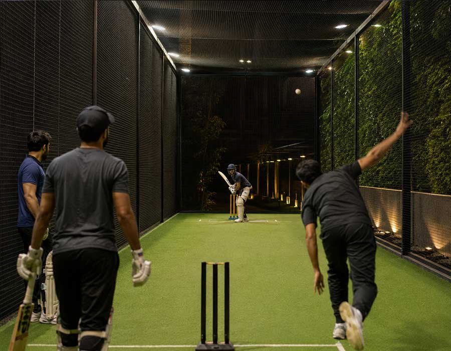 Batsman playing a shot during a box cricket game