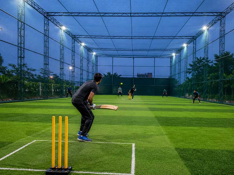 Player batting in a box cricket arena