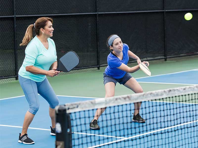 Pickleball players practising on court